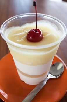 Lemon honey cream panna cotta cup with cherry