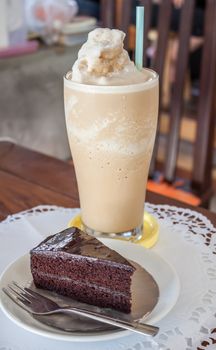 A set of coffee frappe and chocolate cake on the table