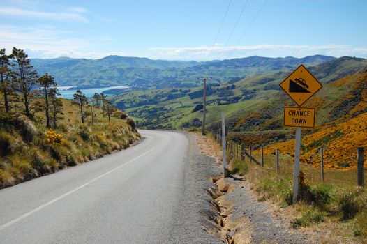 Yellow road sign change down, Akaroa, New Zealand