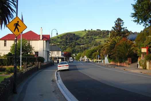 Yellow road sign in Akaroa street, Banks Peninsula, New Zealand
