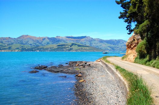 Road along hilly sea coast, Banks Peninsula, New Zealand