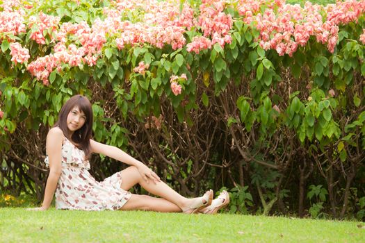 Cute beautyful asian girl portrait in the garden with flowers