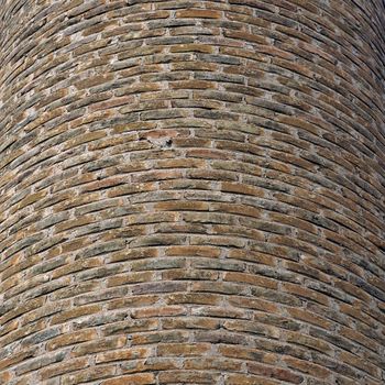 Curved brick wall background texture. Factory chimney detail.