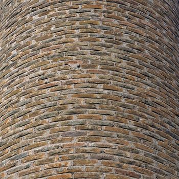 Curved brick wall background texture. Factory chimney detail.