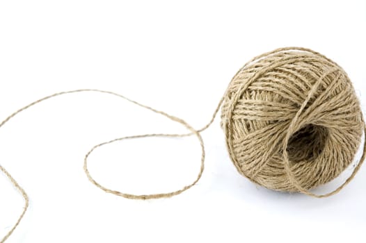 rolling ball of hemp rope on white background