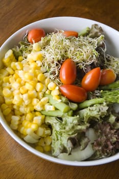 close up mixed salad bowl on table 