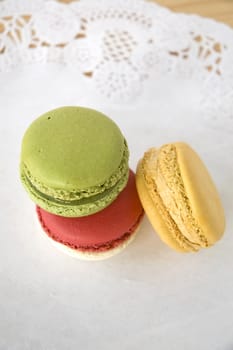 three color french macarons dessert on table