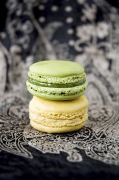 two color macarons on black background