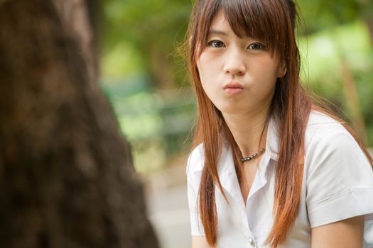 Beautiful young healthy Asian girl portrait in the park