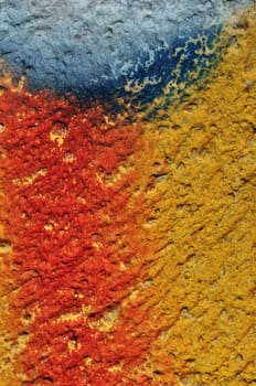 Paint smudged textured plaster and gravel wall abstract background.