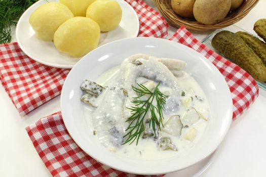 Cream herring with boiled potatoes and cucumber