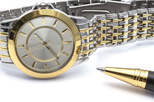 Fashion watch and pen closeup on white