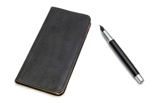 Black book and pen closeup on white background 