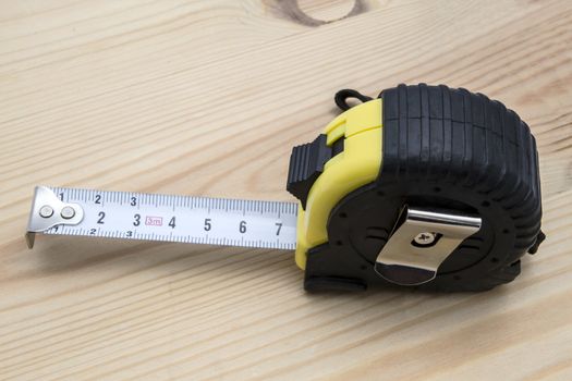 Tape measure closeup on wood background 