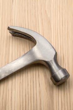 Old hammer isolated on wood background 