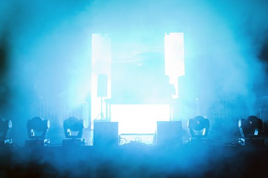 Empty concert stage in disco lights and smoke