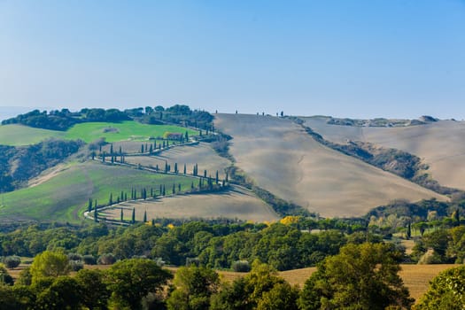 Typical beautiful Tuscan landscape-trees, grass, ski, villa. Italy