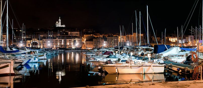 Marseille, France panorama at night. The famous european harbour view on the Notre Dame de la Garde
