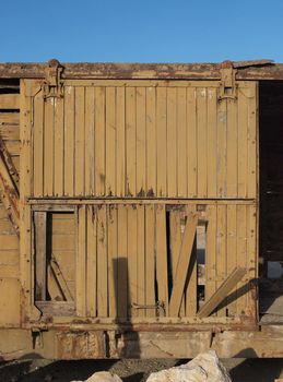 Broken door of abandoned wooden railway car 