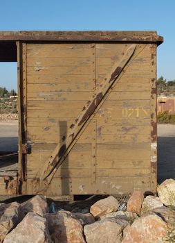 Detail of abandoned wooden railway car standing on props