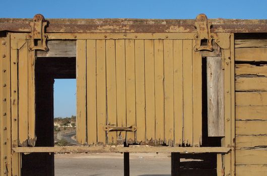 Detail of a broken door of abandoned wooden railway car 