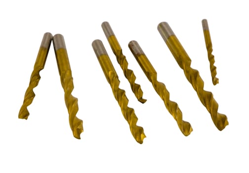 Various size golden drill bits isolated on white background