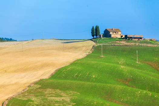 Typical beautiful Tuscan landscape-trees, grass, ski, villa. Italy