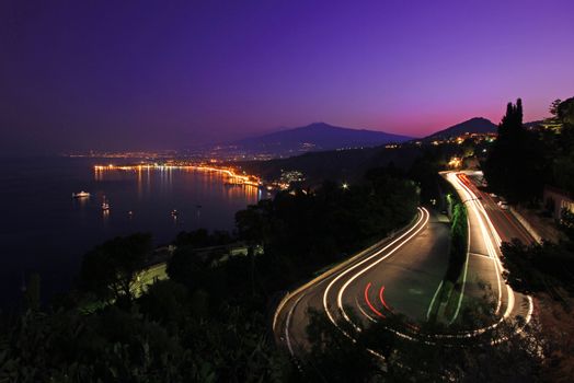 Winding saclian road with mount etna in the back ground sicily the largest of Italies islands