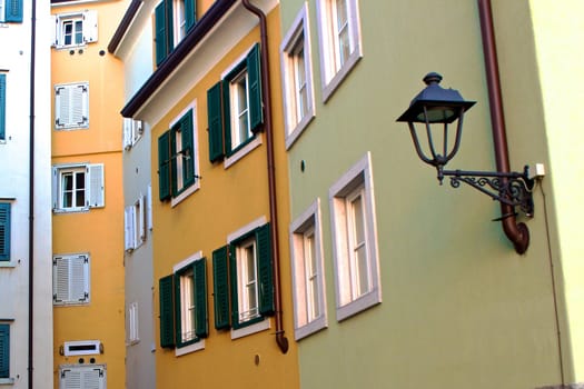 Colorful walls of residential buildings with lamp on a foreground