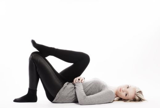 slim girl lying on white