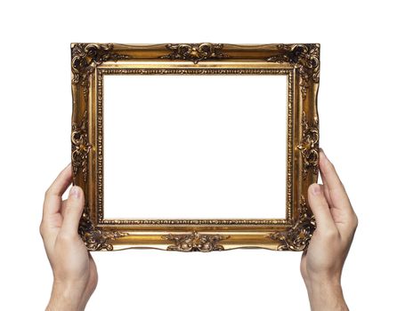 Man holding antique style golden color picture frame in his hands.
