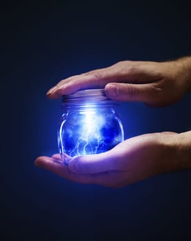 Conceptual image of a man holding a jar with lightnings in his hands.