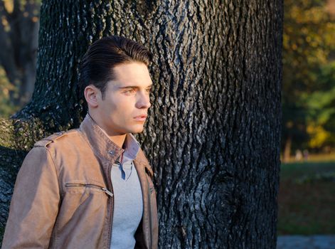 Attractive young male model outdoors in nature, fall setting