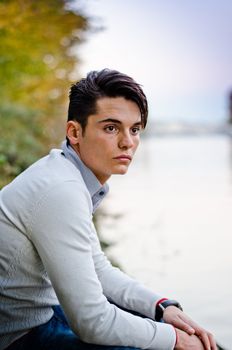 Portrait of handsome young male model on river banks