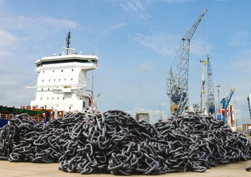 A pile of anchor chain at a shipyard