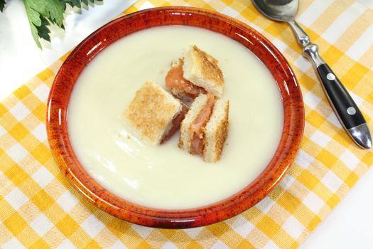 Cream of celery soup with salmon croutons on a checkered napkin