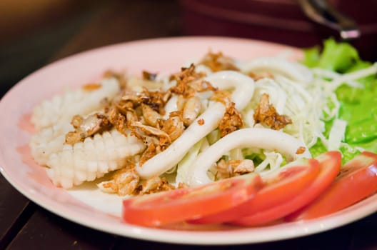 deep fried  squids with fried garlic and fresh vegetable