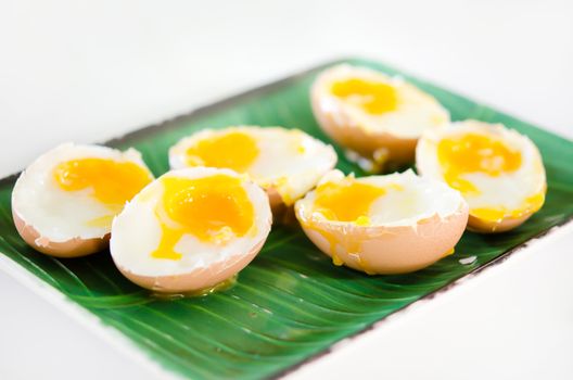 slice of boiled eggs on green plate