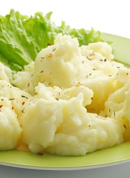 Perfect Mashed Potato with Lettuce on Green Plate closeup