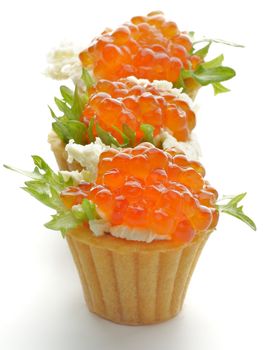 Three Tartlets with Perfect Red Caviar, Greens and Butter in a Row closeup on white background