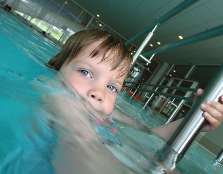 Five year old playing in a swimming pool