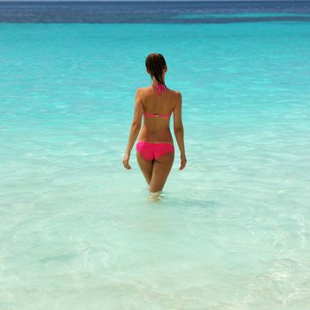 Woman in bikini at tropical beach