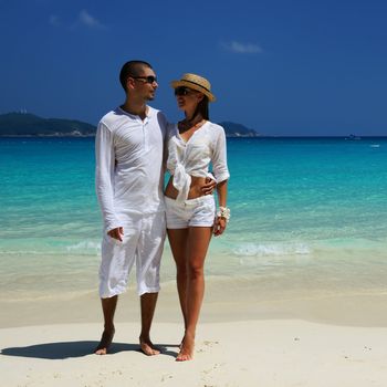 Couple in white on a tropical beach