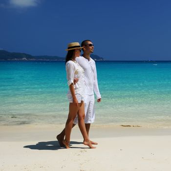 Couple in white on a tropical beach