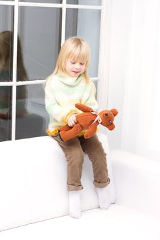 little girl with a teddy bear brown