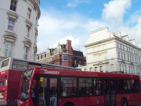 Two red buses neck-to-neck near the Grosvenor Kensington Hotel, South Kensington, London