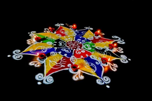 Rangoli, hand sketched patterns and designs filled colored powder are a common item in hindu homes at divali and new year usualy accompanied by ghee (butter) burning candles called diva