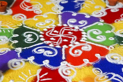 Multi colored patterned rangoli design a ritual performed by hindus generally during the hindu new year and divali along with the light of diwas