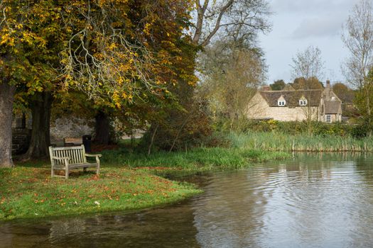 Seat overlooking a deep river at road ford on Shill Brook at Shilton Oxfordshire