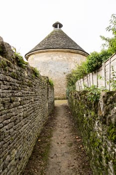 Dovecot of Minster Lovell in Cotswold village with graveyard